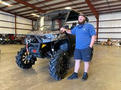 a man standing next to a large vehicle