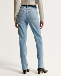 Our classic 90s straight jeans in a medium wash with a raw hem. This fit features an 11.5” ultra high rise, is fitted at top of body and eases through the thigh into a straight leg shape with a full-length inseam. This jean is made from our vintage stretch fabric which features both an authentic vintage look and contains slight built-in stretch for additional comfort. Fitted Straight Cropped Jeans In Rigid Denim, Fitted Straight Leg Cropped Jeans In Rigid Denim, Classic Straight Flare Jeans With Frayed Hem, Relaxed Fit Straight Jeans With Frayed Hem, Straight Jeans With Frayed Hem In Relaxed Fit, Fitted Flare Jeans With Frayed Hem In Rigid Denim, Mom Fit Jeans With Frayed Hem And Straight Leg, Mom Fit Straight Leg Jeans With Frayed Hem, Fitted Straight Silhouette Denim Jeans