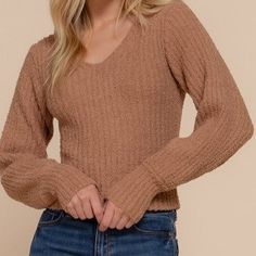 Sweater Girl Top in Camel This classy long sleeve sweater features a v-neck and puffed sleeves. Layer it under your favorite it's-chilly-tonight coat or pair it with jeans and boots.