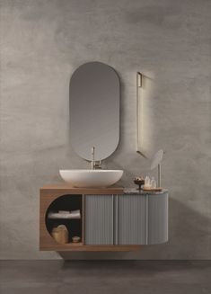 a bathroom with a sink, mirror and vanity in grey colors on the wall next to it