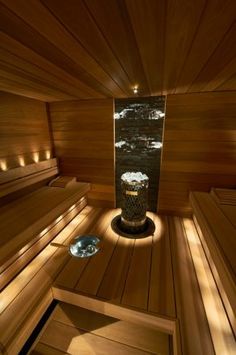 the inside of a wooden sauna with lights on