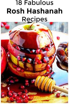 an apple is sitting on top of a table with honey and pomegranates