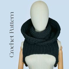 a mannequin wearing a black knitted scarf