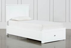 a white bed with two drawers underneath it