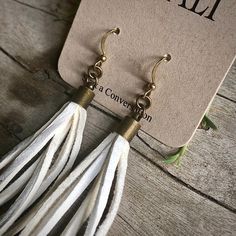 "-These tassel earrings are made from soft white deerskin leather. Part Western, part Boho, part Rock 'n Roll, these little fringe earrings give a big kick to any outfit. -Lightweight enough to wear every day. -3\" - 3.5\" total length, including earwires. -Earwires are antique-brass. -Deerskin leather is sustainably sourced in the USA. -Ok to get wet. -Available in 10 colors. -Designed and handmade in South Pasadena, CA. Check out more of our awesome earrings here: https://www.etsy.com/shop/AST White Bohemian Leather Jewelry, White Leather Bohemian Jewelry, Bohemian White Leather Jewelry, White Fringe Tassel Earrings As Gift, Handmade White Leather Earrings, White Fringe Tassel Drop Earrings, White Tassel Earrings Gift, Gift White Tassel Earrings, White Leather Earrings As A Gift