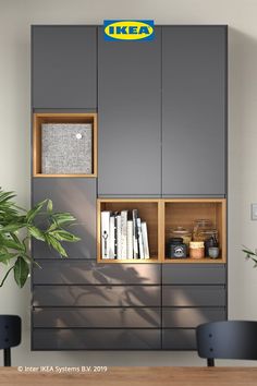 an ikea bookcase with books and magazines on it in front of a potted plant