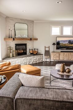 a living room filled with furniture and a fire place in the middle of the room