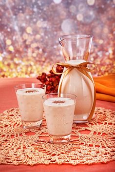 three glasses and a pitcher on a doily