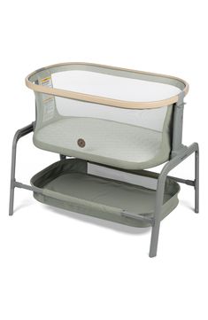 a baby crib that is sitting on top of a stand with the seat up