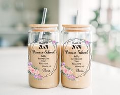 two mason jars filled with peanut butter and topped with straws