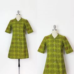 "Vintage 1962 Marimekko cotton shirt dress in the Maruna print by Annika Rimala. deep olive green with bold sketched blooms, some of which have dark brownish orange dots at the center. Mock collar with silver metal buttons from the front neck to hip level. Darted bust with a slight nip at the waist. Medium weight cotton that is unlined. Would best fit a Small ♦ MEASUREMENTS ♦ Shoulder - 14.25\" Bust - 33\" to 34\" Waist - 31.5\" Hips - 36\" Sleeve - 12\" Length - 33.75\" Fabric - cotton Label - Green Mod Cotton Dress, Summer Dress Design, 60s Mod Fashion, Marimekko Dress, Old Hollywood Fashion, Designer Summer Dresses, Vintage Dress 60s, Seventies Fashion, Floral Summer Dress