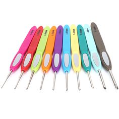 six different colored kitchen utensils lined up in a row