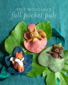 felt woodland fall pocket pals are displayed on a green cloth with leaves and flowers