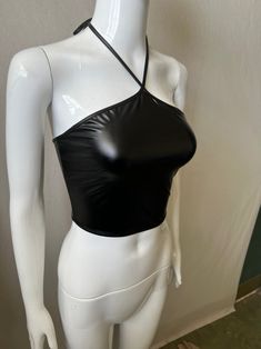 Make a bold statement with our Shakira Leather Backless Top, a perfect blend of edgy and sexy. Crafted from high-quality faux leather, this slim-fit top features a solid pattern that exudes confidence and style. The halter neckline and daring backless design create a striking silhouette, perfect for making a lasting impression. Designed for summer, this cropped halter tank keeps you cool while turning up the heat on your fashion game. Whether you're heading to a night out with friends or a speci Leather Halter Top, Leather Halter, Tube Tops, Halter Tank, Backless Top, Slim Fit Top, Backless Design, Shakira, Halter Neckline