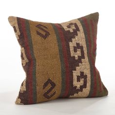 a brown and black striped pillow sitting on top of a white floor