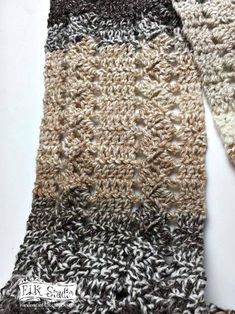 two crocheted scarves sitting next to each other