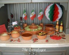 an assortment of food on a counter with mexican flags in the backgroung