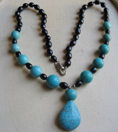 "CHRISTMAS SPECIAL: This is a beautiful turquoise pendant made into a necklace out of turquoise beads and black sea pearls. As seen in the pictures half of the necklace is made from black sea pearls alone and then turns into pearl and turquoise spaced every other one. The turquoise pendant is 1 1/4\" in length and then resting on it is a14mm turquoise bead. The necklace is 18\" in length and is attached together with a silver plated connector clamp." Elegant Turquoise Jewelry With Black Beads, Turquoise Beaded Necklaces With Black Beads As Gift, Blue Turquoise Teardrop Necklace With Gemstone Beads, Gift Turquoise Beaded Necklaces With Black Beads, Turquoise Jewelry With Black Beads For Gift, Turquoise Necklace With Black Beads As Gift, Blue Necklace With Black Beads For Gift, Necklace Ideas, Bead Necklaces