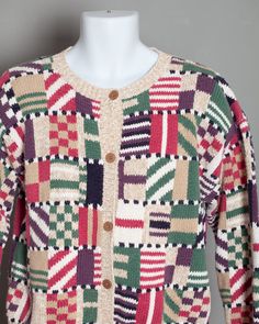 a multicolored cardigan sweater on a mannequin head