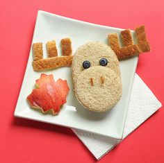 a plate that has food on it and some type of animal made out of bread