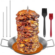 a stack of food sitting on top of a pan with utensils next to it