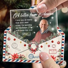 a hand holding an envelope with a christmas card attached to it and the message, a letter from heaven