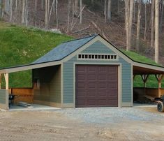 a golf cart is parked in front of a garage with a green roof and grass on top