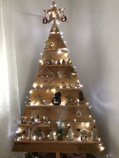 a wooden christmas tree with lights on it