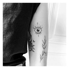 a woman's arm with an all seeing eye tattoo on the left side of her arm