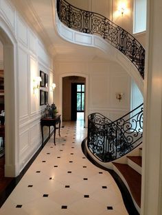 an elegant foyer with black and white tile flooring