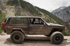 a jeep is parked on the side of a mountain