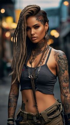 a woman with long dreadlocks and tattoos on her chest is standing in the street