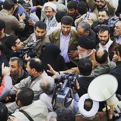 a large group of people standing around each other