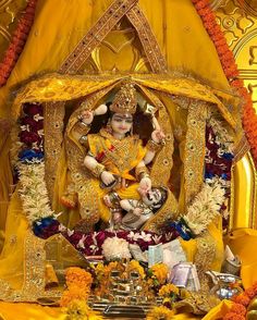 the statue is surrounded by flowers and decorations