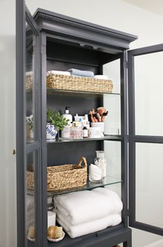 the shelves in this bathroom are filled with towels and toiletries, such as bath products