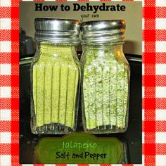 two jars filled with green food sitting on top of a table