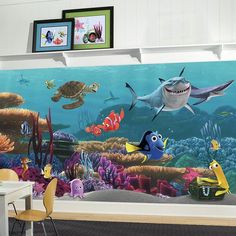 an underwater scene with fish, sharks and other marine life on the wall behind a chair