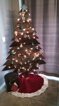 a wooden christmas tree with lights on it