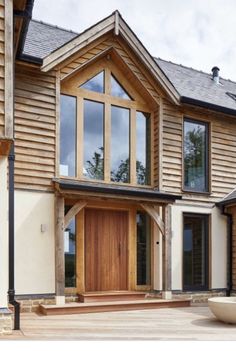 a large wooden house with lots of windows