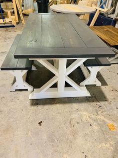 a table made out of two different pieces of wood sitting on top of a floor