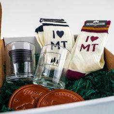 a box filled with two glasses and some socks