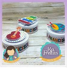 three small tins with stickers on them sitting next to each other in front of a wooden table