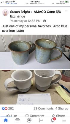 two coffee mugs sitting on top of a table next to a piece of paper