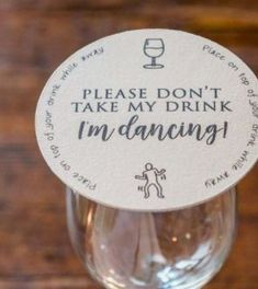 a wine glass with a label on it that says, please don't take my drink i'm dancing