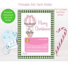 a christmas card with a hot air balloon on it and candy canes next to it