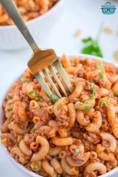 a fork in a bowl filled with pasta