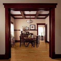 a dining room with wood floors and white walls