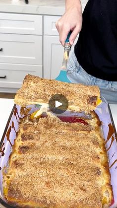 a person cutting into a dessert in a pan on top of a counter with a spatula