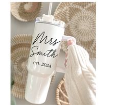 a person holding a white coffee cup with the words, miss smith est 2021 on it