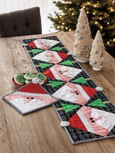 a christmas table runner with santa clause on it